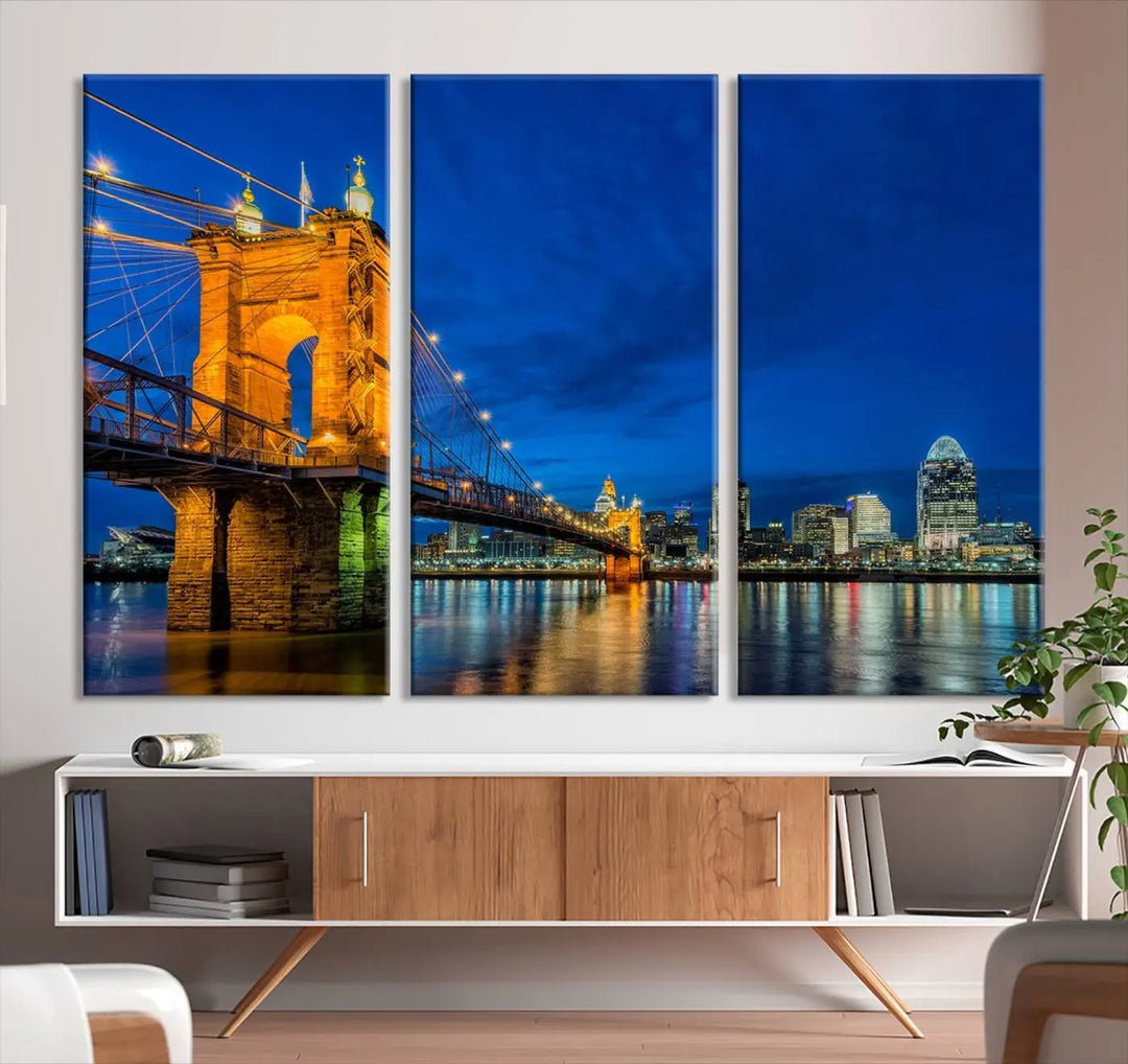 The living room features a museum-quality, multi-panel wall art titled "Cincinnati City Bridge Lights Night Skyline Cityscape View Wall Art Canvas Print," which depicts a lit-up bridge at night. The gallery-wrapped canvas adds a touch of elegance to the space.