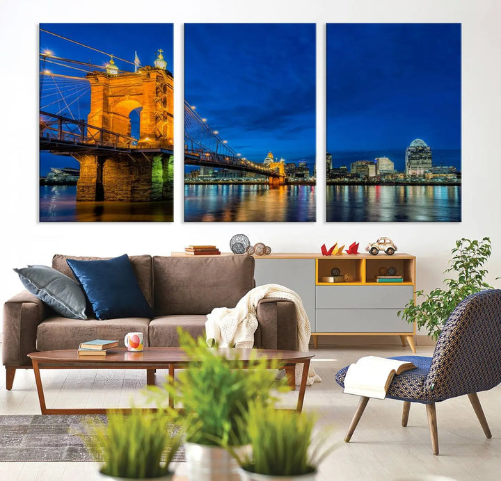 The living room features a museum-quality, multi-panel wall art titled "Cincinnati City Bridge Lights Night Skyline Cityscape View Wall Art Canvas Print," which depicts a lit-up bridge at night. The gallery-wrapped canvas adds a touch of elegance to the space.