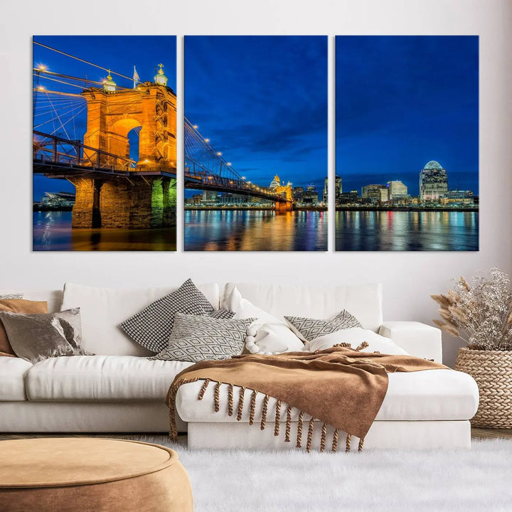 The living room features a museum-quality, multi-panel wall art titled "Cincinnati City Bridge Lights Night Skyline Cityscape View Wall Art Canvas Print," which depicts a lit-up bridge at night. The gallery-wrapped canvas adds a touch of elegance to the space.