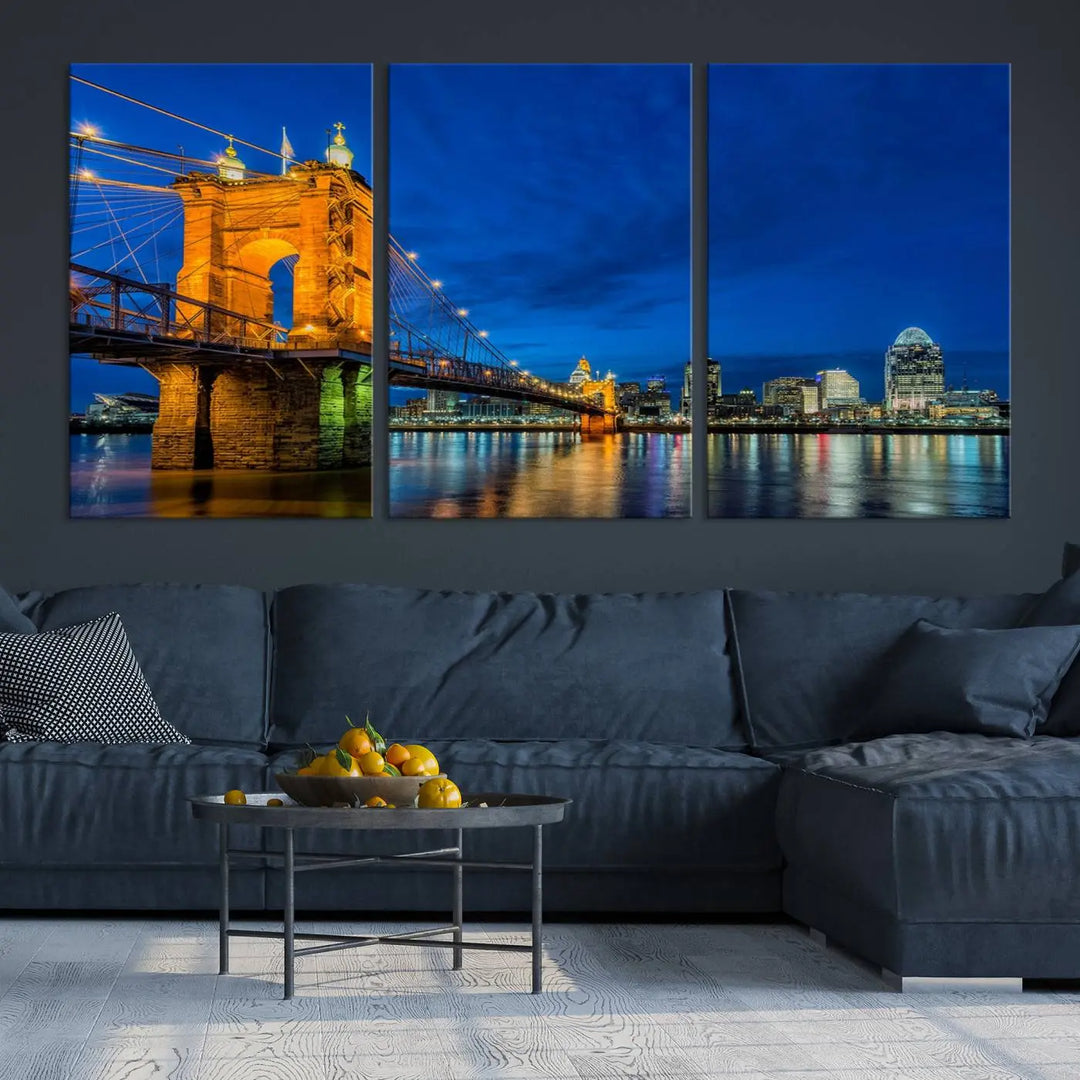 The living room features a museum-quality, multi-panel wall art titled "Cincinnati City Bridge Lights Night Skyline Cityscape View Wall Art Canvas Print," which depicts a lit-up bridge at night. The gallery-wrapped canvas adds a touch of elegance to the space.