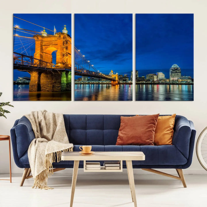 The living room features a museum-quality, multi-panel wall art titled "Cincinnati City Bridge Lights Night Skyline Cityscape View Wall Art Canvas Print," which depicts a lit-up bridge at night. The gallery-wrapped canvas adds a touch of elegance to the space.