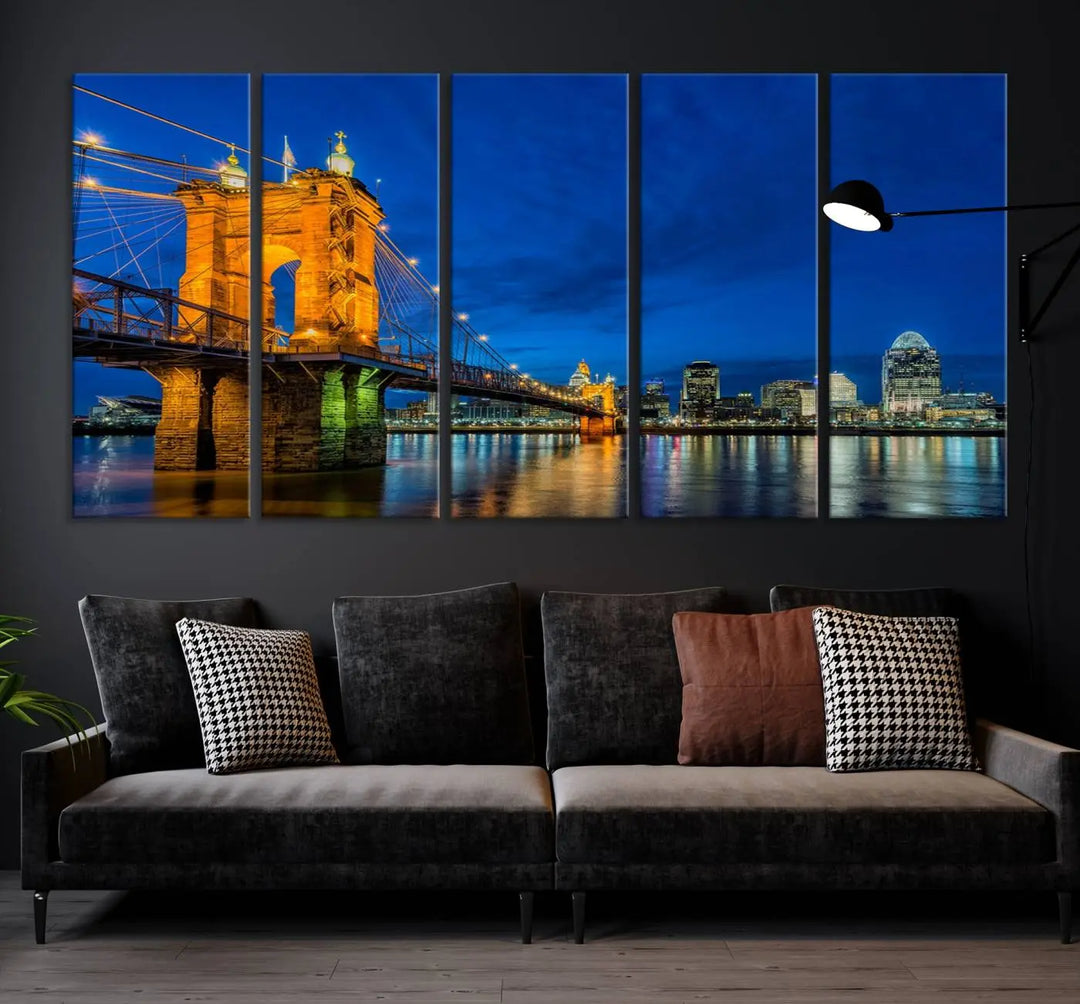 The living room features a museum-quality, multi-panel wall art titled "Cincinnati City Bridge Lights Night Skyline Cityscape View Wall Art Canvas Print," which depicts a lit-up bridge at night. The gallery-wrapped canvas adds a touch of elegance to the space.