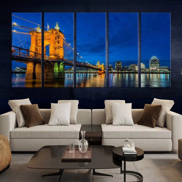 The living room features a museum-quality, multi-panel wall art titled "Cincinnati City Bridge Lights Night Skyline Cityscape View Wall Art Canvas Print," which depicts a lit-up bridge at night. The gallery-wrapped canvas adds a touch of elegance to the space.