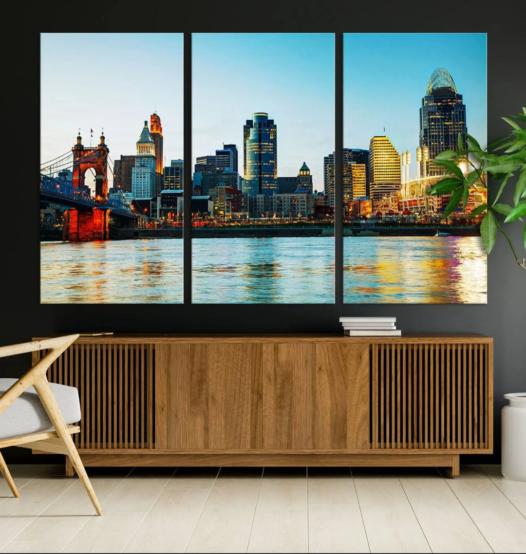 The "Cincinnati City Lights Bright Blue Skyline Cityscape View Wall Art Canvas Print" is a stunning triptych crafted on museum-quality canvas with a UV-protective coating to maintain its vivid colors. Ready to hang, it effortlessly elevates any space with its timeless allure.