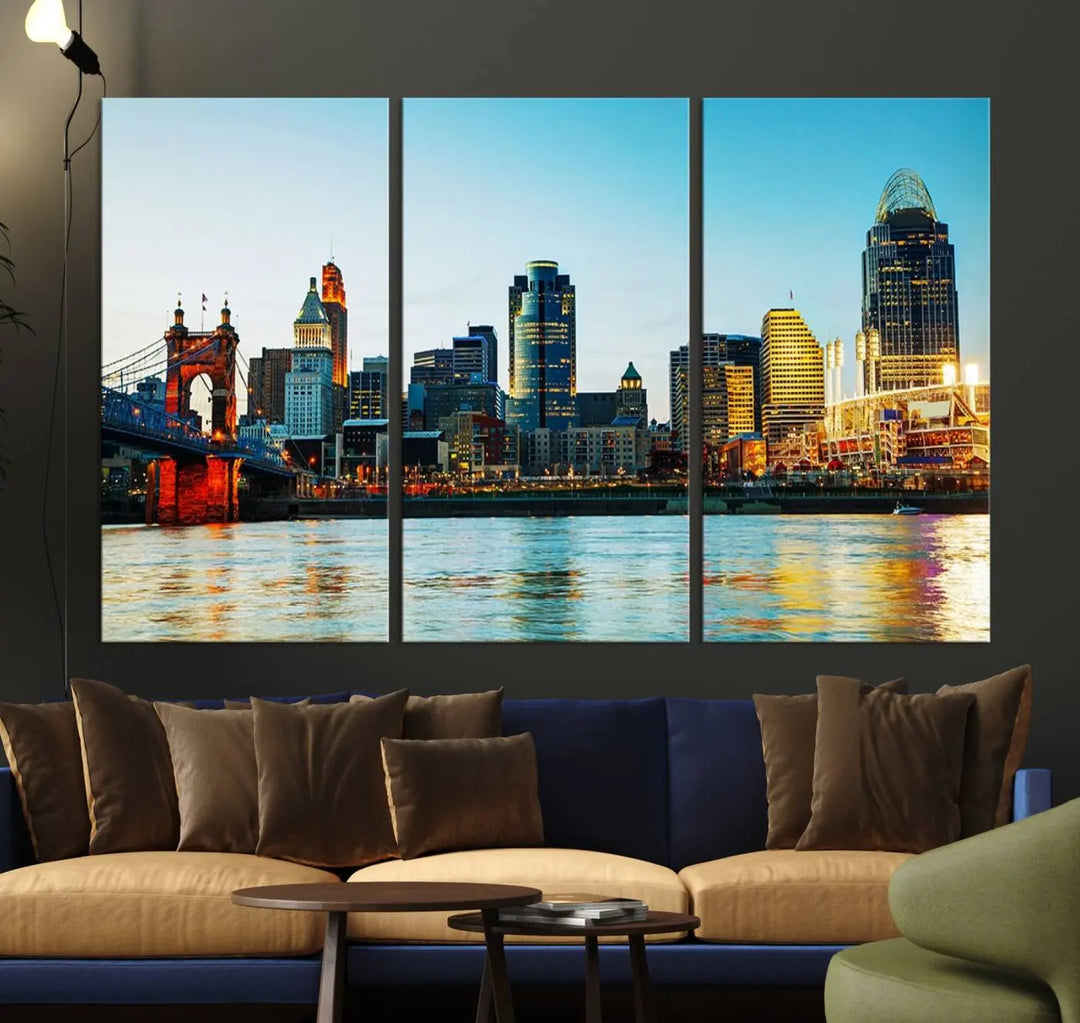 The "Cincinnati City Lights Bright Blue Skyline Cityscape View Wall Art Canvas Print" is a stunning triptych crafted on museum-quality canvas with a UV-protective coating to maintain its vivid colors. Ready to hang, it effortlessly elevates any space with its timeless allure.