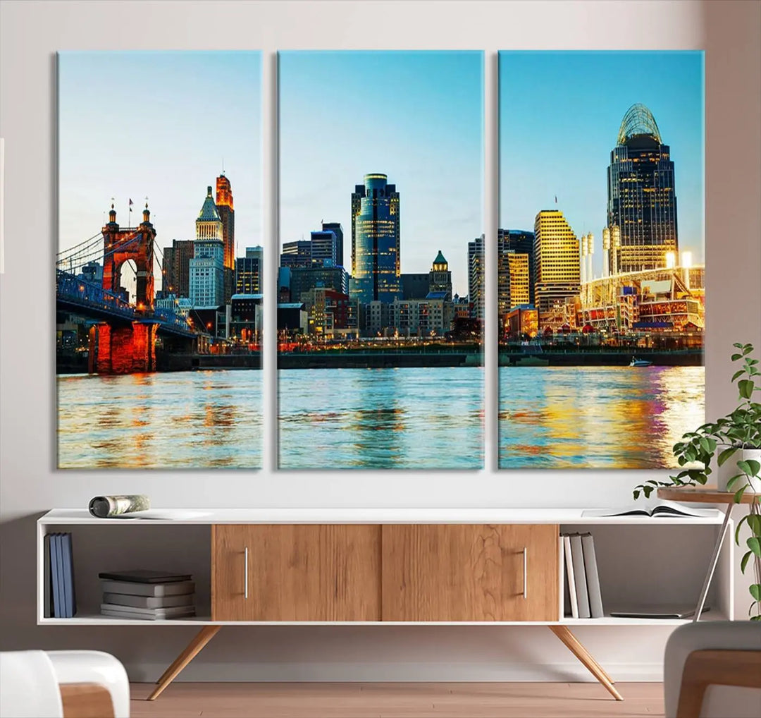 The "Cincinnati City Lights Bright Blue Skyline Cityscape View Wall Art Canvas Print" is a stunning triptych crafted on museum-quality canvas with a UV-protective coating to maintain its vivid colors. Ready to hang, it effortlessly elevates any space with its timeless allure.