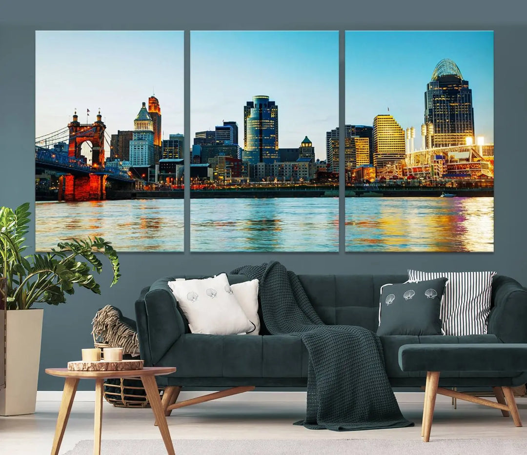 The "Cincinnati City Lights Bright Blue Skyline Cityscape View Wall Art Canvas Print" is a stunning triptych crafted on museum-quality canvas with a UV-protective coating to maintain its vivid colors. Ready to hang, it effortlessly elevates any space with its timeless allure.