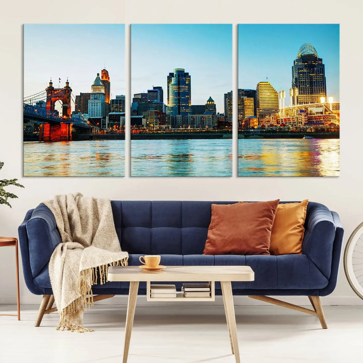 The "Cincinnati City Lights Bright Blue Skyline Cityscape View Wall Art Canvas Print" is a stunning triptych crafted on museum-quality canvas with a UV-protective coating to maintain its vivid colors. Ready to hang, it effortlessly elevates any space with its timeless allure.