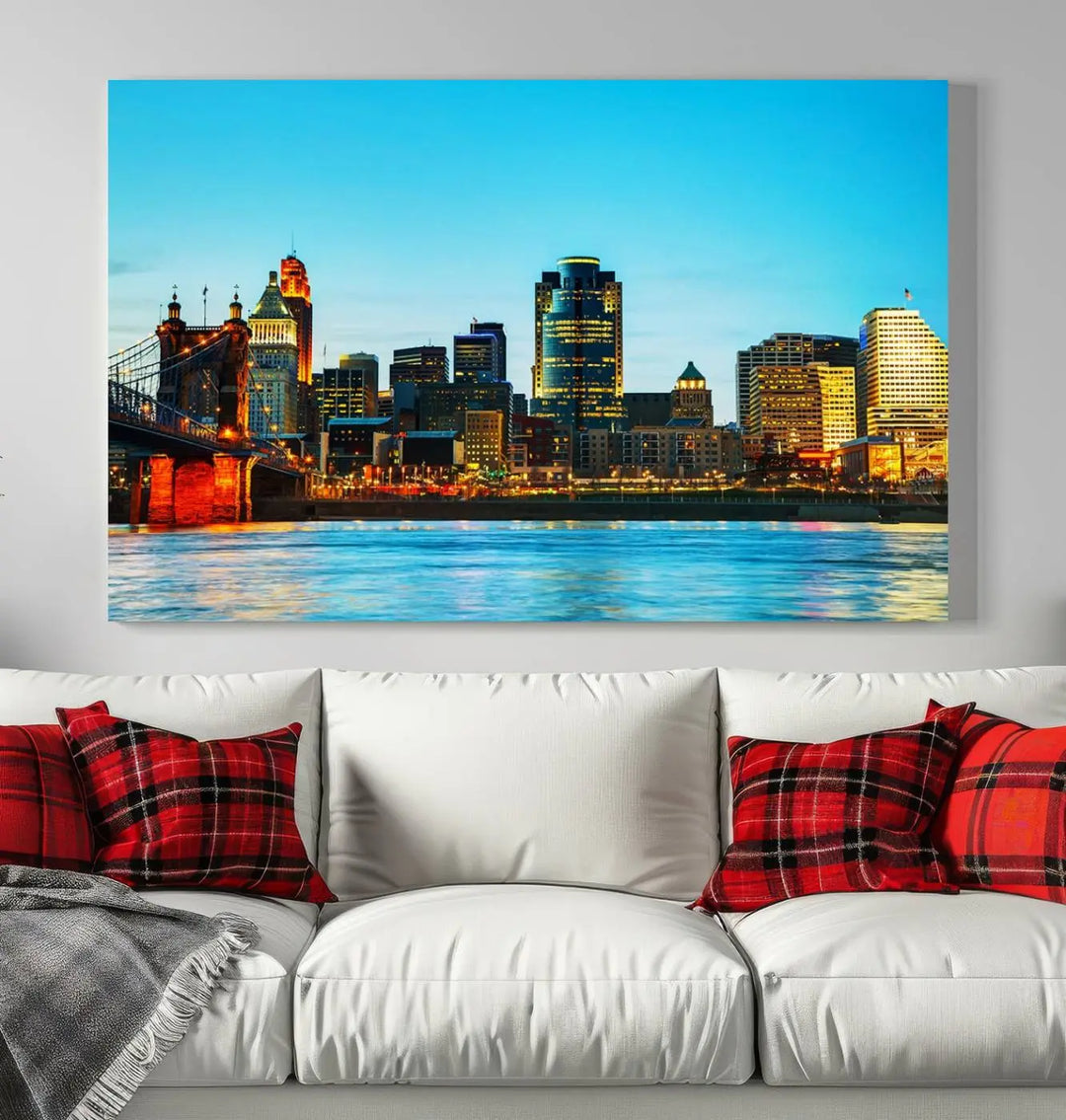 The "Cincinnati City Lights Bright Blue Skyline Cityscape View Wall Art Canvas Print" is displayed as a three-panel masterpiece. Expertly crafted on museum-quality polycotton canvas with a UV-protective coating, this artwork captures the essence of the city at dusk.