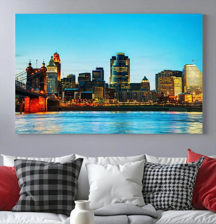 The "Cincinnati City Lights Bright Blue Skyline Cityscape View Wall Art Canvas Print" is displayed as a three-panel masterpiece. Expertly crafted on museum-quality polycotton canvas with a UV-protective coating, this artwork captures the essence of the city at dusk.