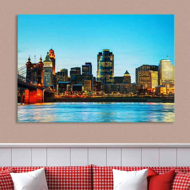 The "Cincinnati City Lights Bright Blue Skyline Cityscape View Wall Art Canvas Print" is displayed as a three-panel masterpiece. Expertly crafted on museum-quality polycotton canvas with a UV-protective coating, this artwork captures the essence of the city at dusk.