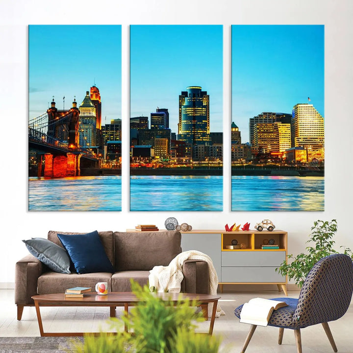 The "Cincinnati City Lights Bright Blue Skyline Cityscape View Wall Art Canvas Print" is displayed as a three-panel masterpiece. Expertly crafted on museum-quality polycotton canvas with a UV-protective coating, this artwork captures the essence of the city at dusk.