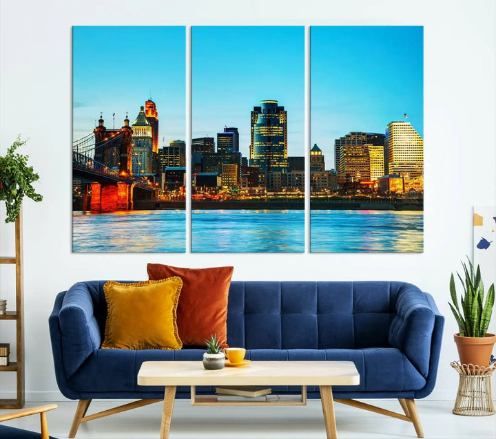 The "Cincinnati City Lights Bright Blue Skyline Cityscape View Wall Art Canvas Print" is displayed as a three-panel masterpiece. Expertly crafted on museum-quality polycotton canvas with a UV-protective coating, this artwork captures the essence of the city at dusk.