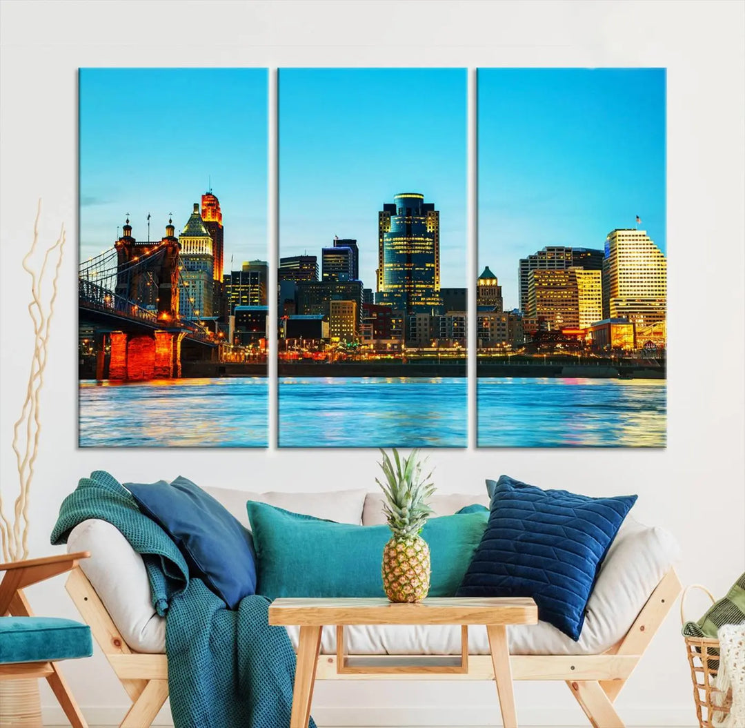 The "Cincinnati City Lights Bright Blue Skyline Cityscape View Wall Art Canvas Print" is displayed as a three-panel masterpiece. Expertly crafted on museum-quality polycotton canvas with a UV-protective coating, this artwork captures the essence of the city at dusk.