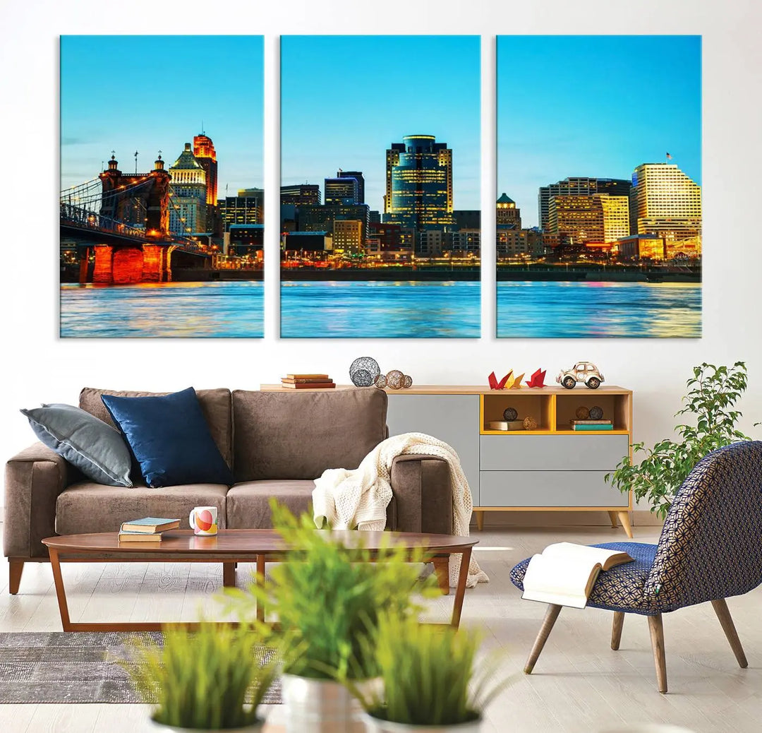 The "Cincinnati City Lights Bright Blue Skyline Cityscape View Wall Art Canvas Print" is displayed as a three-panel masterpiece. Expertly crafted on museum-quality polycotton canvas with a UV-protective coating, this artwork captures the essence of the city at dusk.