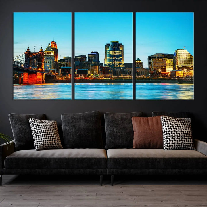 The "Cincinnati City Lights Bright Blue Skyline Cityscape View Wall Art Canvas Print" is displayed as a three-panel masterpiece. Expertly crafted on museum-quality polycotton canvas with a UV-protective coating, this artwork captures the essence of the city at dusk.