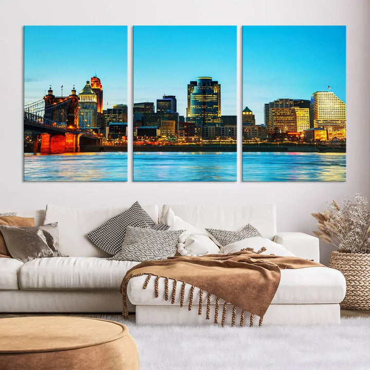 The "Cincinnati City Lights Bright Blue Skyline Cityscape View Wall Art Canvas Print" is displayed as a three-panel masterpiece. Expertly crafted on museum-quality polycotton canvas with a UV-protective coating, this artwork captures the essence of the city at dusk.