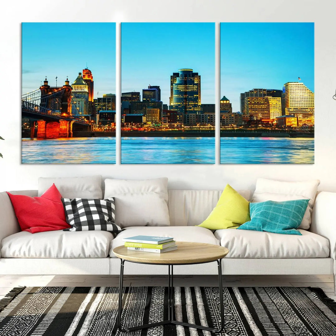 The "Cincinnati City Lights Bright Blue Skyline Cityscape View Wall Art Canvas Print" is displayed as a three-panel masterpiece. Expertly crafted on museum-quality polycotton canvas with a UV-protective coating, this artwork captures the essence of the city at dusk.