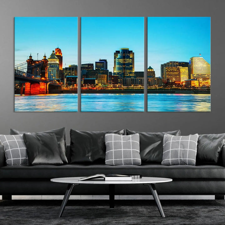 The "Cincinnati City Lights Bright Blue Skyline Cityscape View Wall Art Canvas Print" is displayed as a three-panel masterpiece. Expertly crafted on museum-quality polycotton canvas with a UV-protective coating, this artwork captures the essence of the city at dusk.