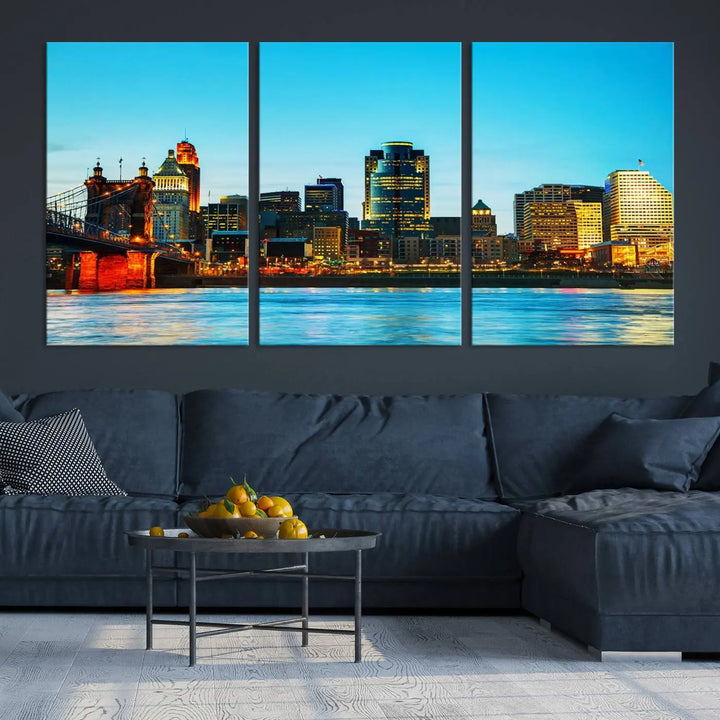 The "Cincinnati City Lights Bright Blue Skyline Cityscape View Wall Art Canvas Print" is displayed as a three-panel masterpiece. Expertly crafted on museum-quality polycotton canvas with a UV-protective coating, this artwork captures the essence of the city at dusk.