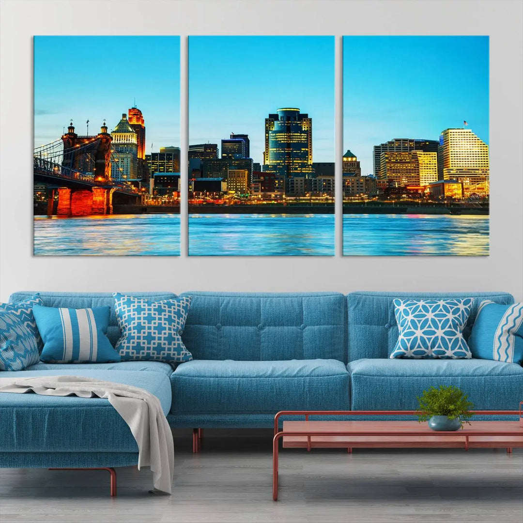 The "Cincinnati City Lights Bright Blue Skyline Cityscape View Wall Art Canvas Print" is displayed as a three-panel masterpiece. Expertly crafted on museum-quality polycotton canvas with a UV-protective coating, this artwork captures the essence of the city at dusk.