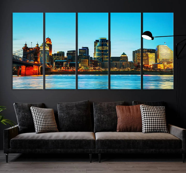 The "Cincinnati City Lights Bright Blue Skyline Cityscape View Wall Art Canvas Print" is displayed as a three-panel masterpiece. Expertly crafted on museum-quality polycotton canvas with a UV-protective coating, this artwork captures the essence of the city at dusk.