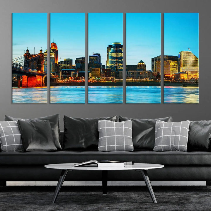 The "Cincinnati City Lights Bright Blue Skyline Cityscape View Wall Art Canvas Print" is displayed as a three-panel masterpiece. Expertly crafted on museum-quality polycotton canvas with a UV-protective coating, this artwork captures the essence of the city at dusk.