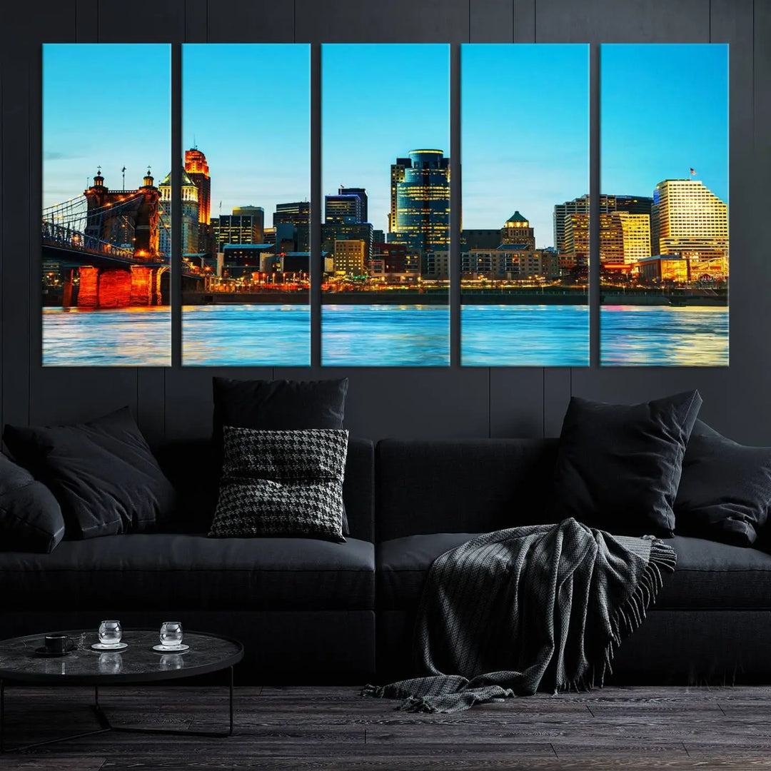 The "Cincinnati City Lights Bright Blue Skyline Cityscape View Wall Art Canvas Print" is displayed as a three-panel masterpiece. Expertly crafted on museum-quality polycotton canvas with a UV-protective coating, this artwork captures the essence of the city at dusk.