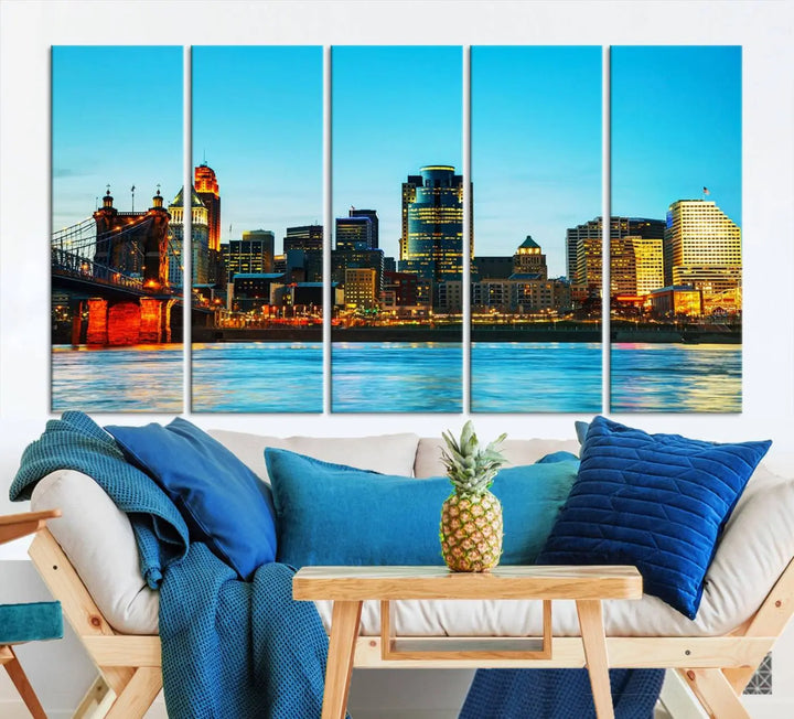 The "Cincinnati City Lights Bright Blue Skyline Cityscape View Wall Art Canvas Print" is displayed as a three-panel masterpiece. Expertly crafted on museum-quality polycotton canvas with a UV-protective coating, this artwork captures the essence of the city at dusk.