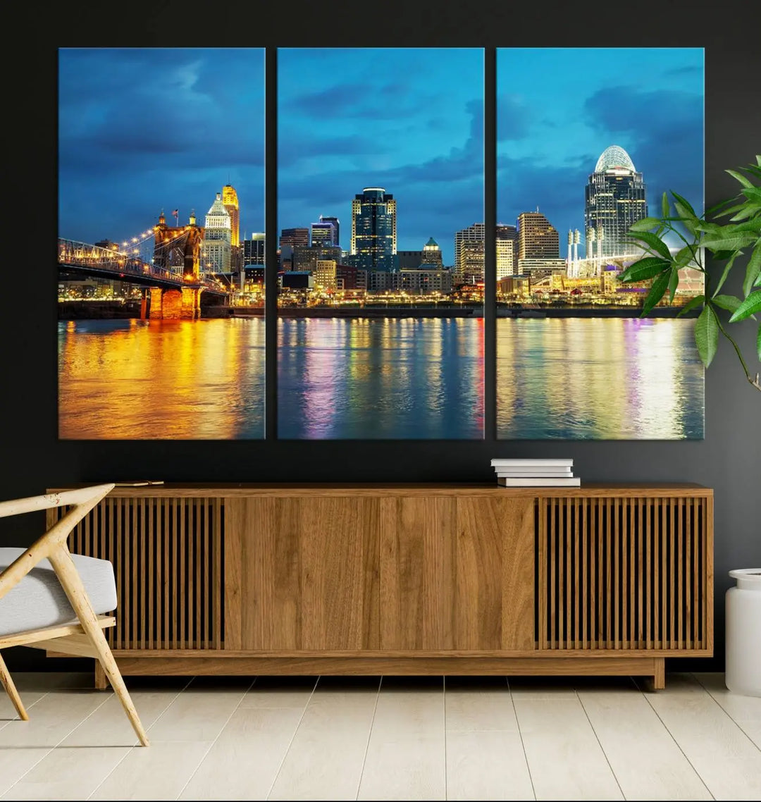 Displayed on a museum-quality canvas, the "Cincinnati City Lights Night Blue Skyline Cityscape View Wall Art Canvas Print" captures the city skyline's reflection in water at night.