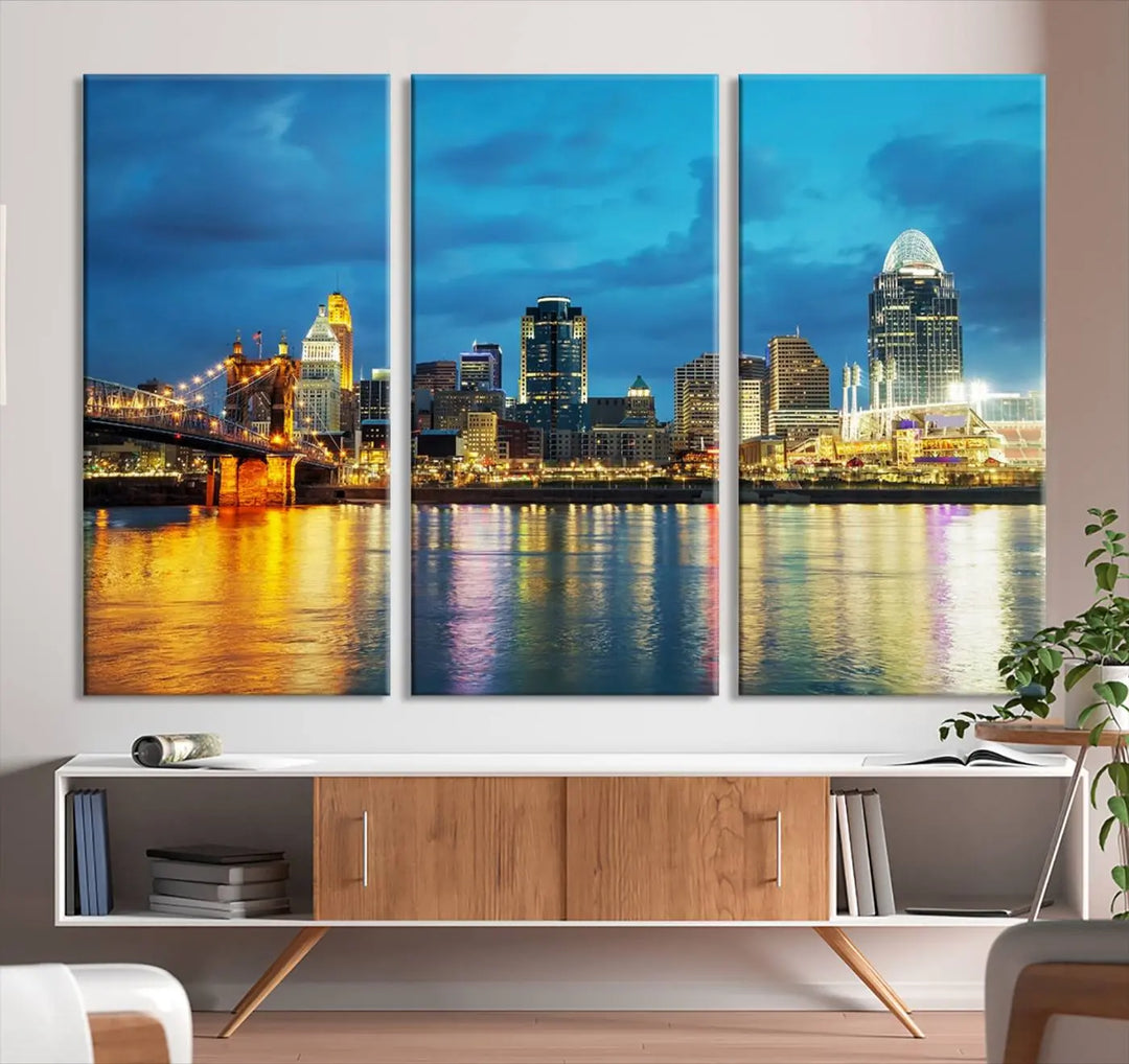 Displayed on a museum-quality canvas, the "Cincinnati City Lights Night Blue Skyline Cityscape View Wall Art Canvas Print" captures the city skyline's reflection in water at night.