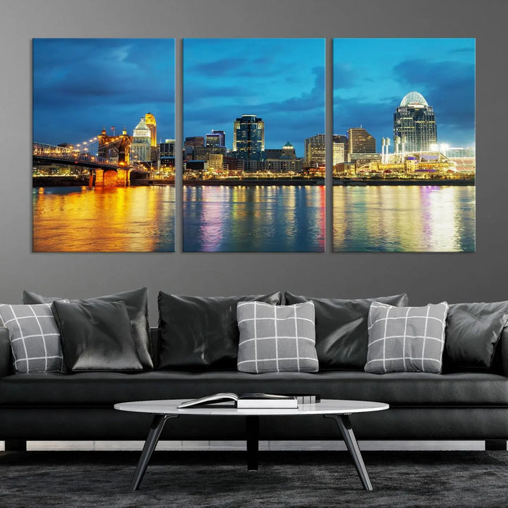 Displayed on a museum-quality canvas, the "Cincinnati City Lights Night Blue Skyline Cityscape View Wall Art Canvas Print" captures the city skyline's reflection in water at night.