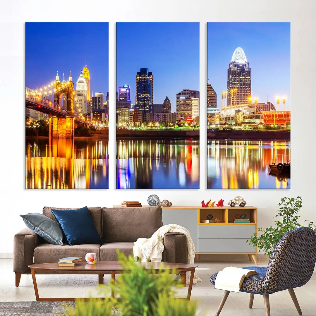 The "Cincinnati City Lights Night Skyline Cityscape View Wall Art Canvas Print" is a gallery-wrapped, museum-quality canvas illustrating a lit-up bridge and skyline at night. Enhanced with a UV-protective coating, this piece ensures lasting vibrancy.