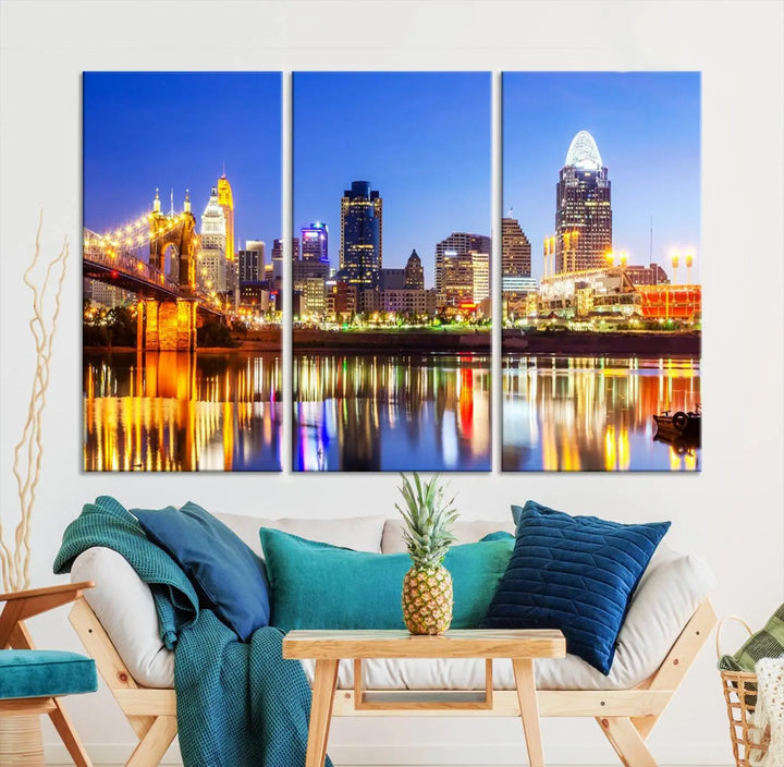 The "Cincinnati City Lights Night Skyline Cityscape View Wall Art Canvas Print" is a gallery-wrapped, museum-quality canvas illustrating a lit-up bridge and skyline at night. Enhanced with a UV-protective coating, this piece ensures lasting vibrancy.