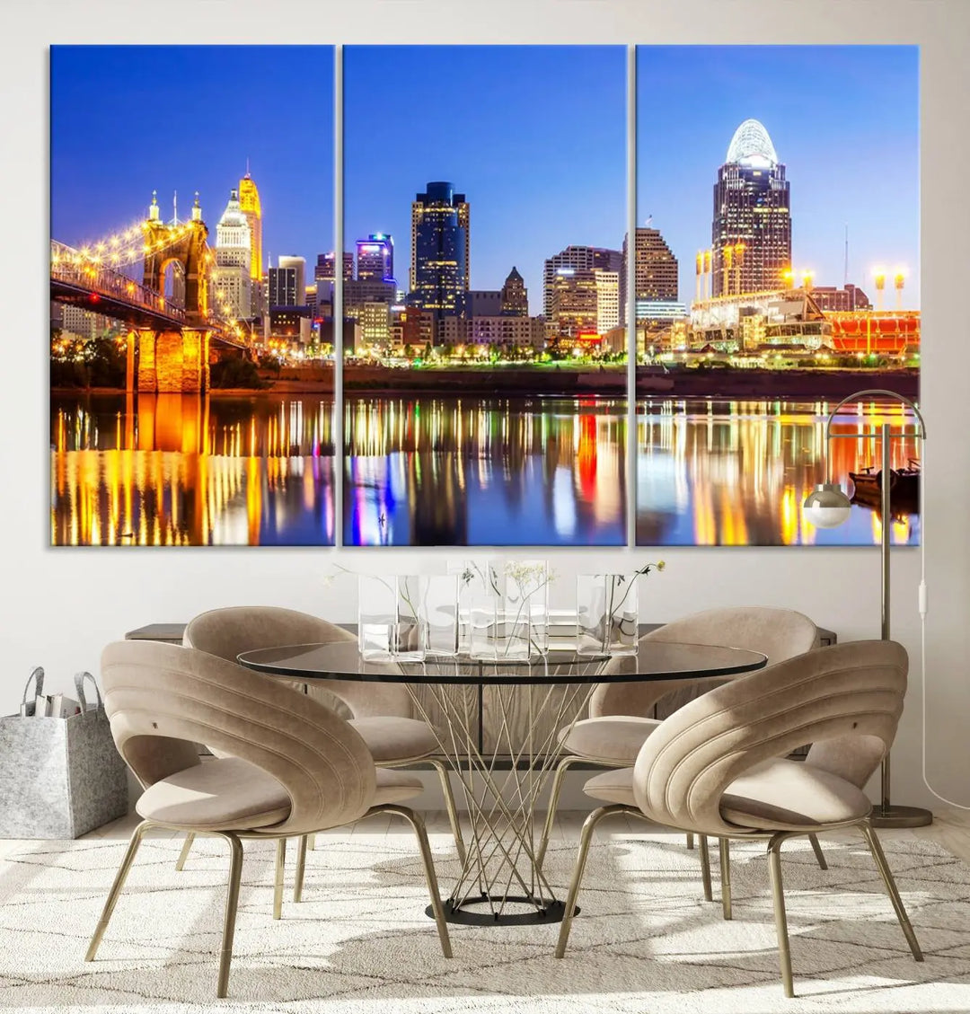 The "Cincinnati City Lights Night Skyline Cityscape View Wall Art Canvas Print" is a gallery-wrapped, museum-quality canvas illustrating a lit-up bridge and skyline at night. Enhanced with a UV-protective coating, this piece ensures lasting vibrancy.