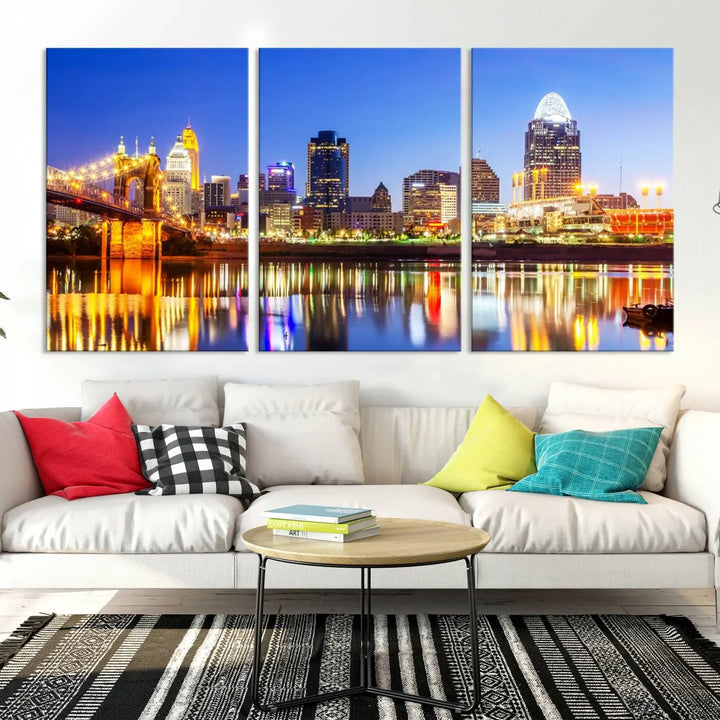 The "Cincinnati City Lights Night Skyline Cityscape View Wall Art Canvas Print" is a gallery-wrapped, museum-quality canvas illustrating a lit-up bridge and skyline at night. Enhanced with a UV-protective coating, this piece ensures lasting vibrancy.