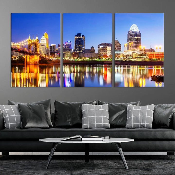 The "Cincinnati City Lights Night Skyline Cityscape View Wall Art Canvas Print" is a gallery-wrapped, museum-quality canvas illustrating a lit-up bridge and skyline at night. Enhanced with a UV-protective coating, this piece ensures lasting vibrancy.