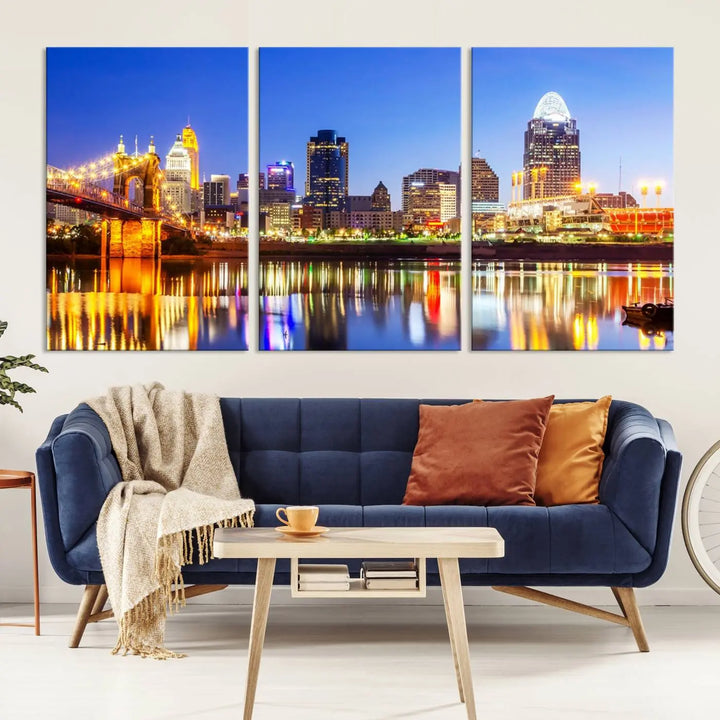 The "Cincinnati City Lights Night Skyline Cityscape View Wall Art Canvas Print" is a gallery-wrapped, museum-quality canvas illustrating a lit-up bridge and skyline at night. Enhanced with a UV-protective coating, this piece ensures lasting vibrancy.