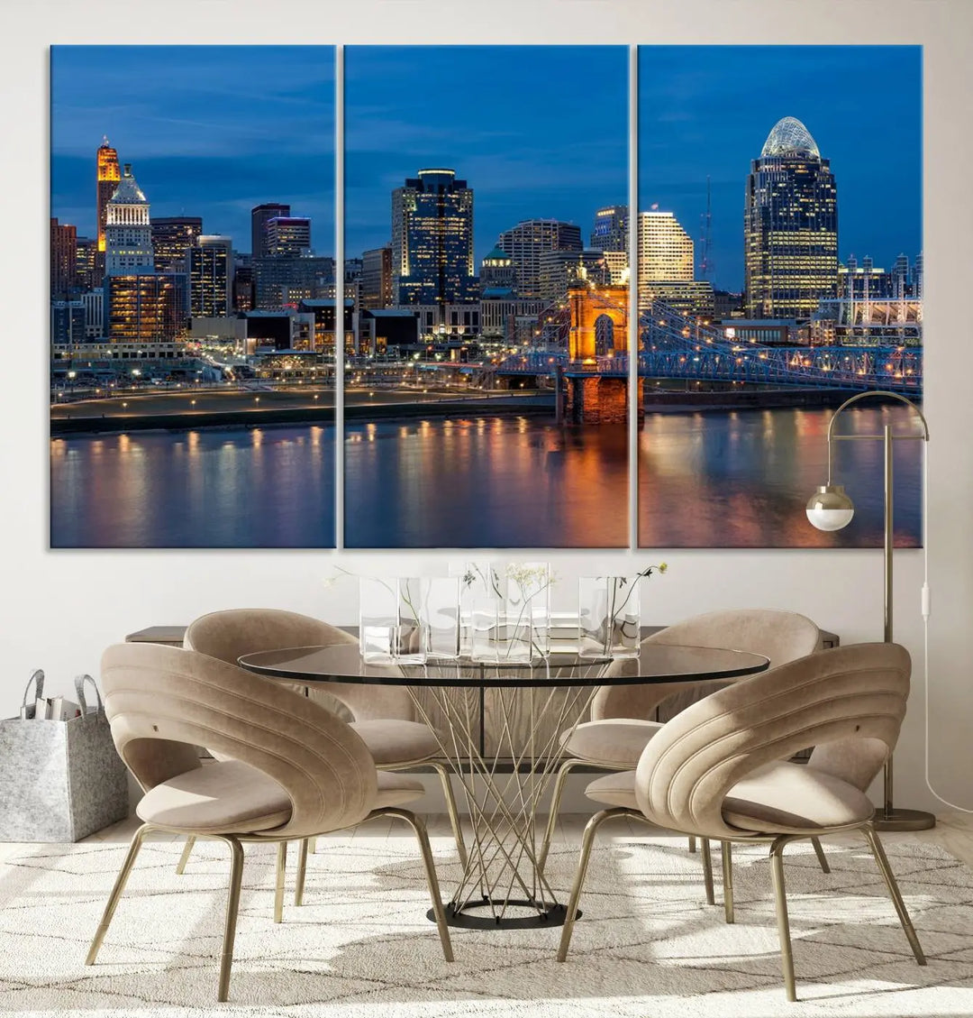 A triptych of the Cincinnati city lights night skyline, printed on museum-quality canvas with a UV-protective coating, hangs prominently on the wall.