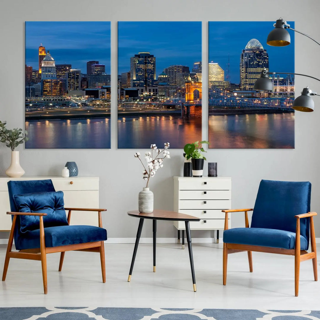 A triptych of the Cincinnati city lights night skyline, printed on museum-quality canvas with a UV-protective coating, hangs prominently on the wall.