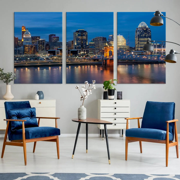 A triptych of the Cincinnati city lights night skyline, printed on museum-quality canvas with a UV-protective coating, hangs prominently on the wall.