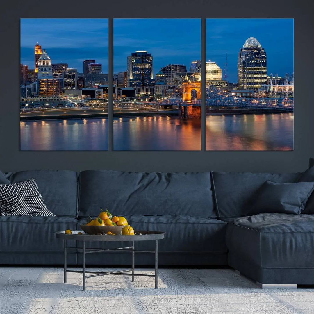 A triptych of the Cincinnati city lights night skyline, printed on museum-quality canvas with a UV-protective coating, hangs prominently on the wall.