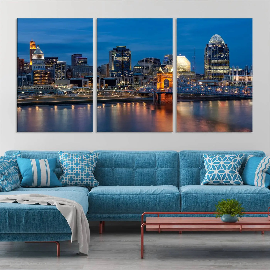 A triptych of the Cincinnati city lights night skyline, printed on museum-quality canvas with a UV-protective coating, hangs prominently on the wall.