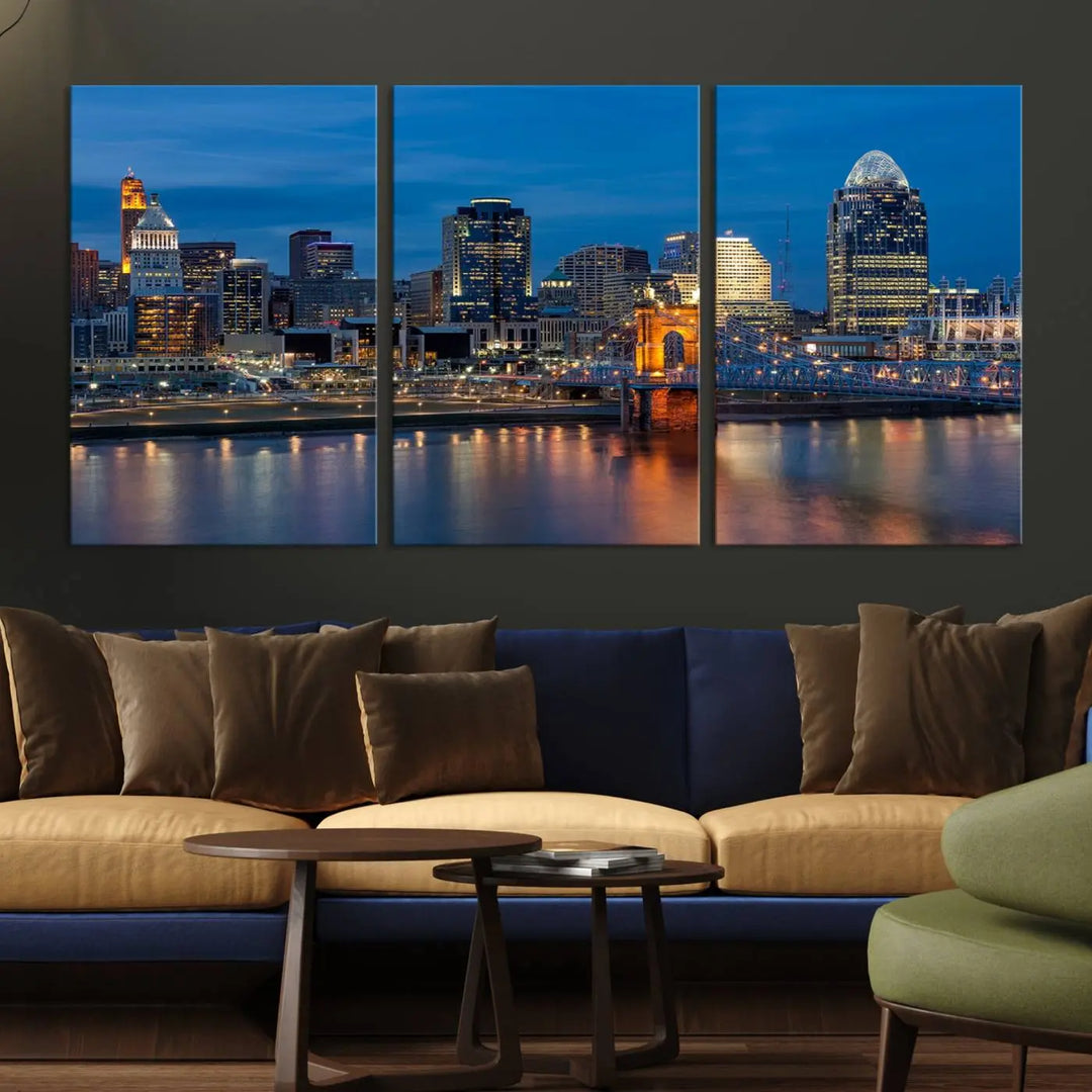 A triptych of the Cincinnati city lights night skyline, printed on museum-quality canvas with a UV-protective coating, hangs prominently on the wall.