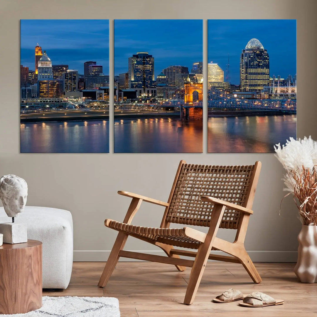 A triptych of the Cincinnati city lights night skyline, printed on museum-quality canvas with a UV-protective coating, hangs prominently on the wall.