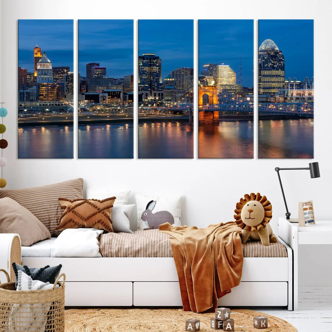 A triptych of the Cincinnati city lights night skyline, printed on museum-quality canvas with a UV-protective coating, hangs prominently on the wall.