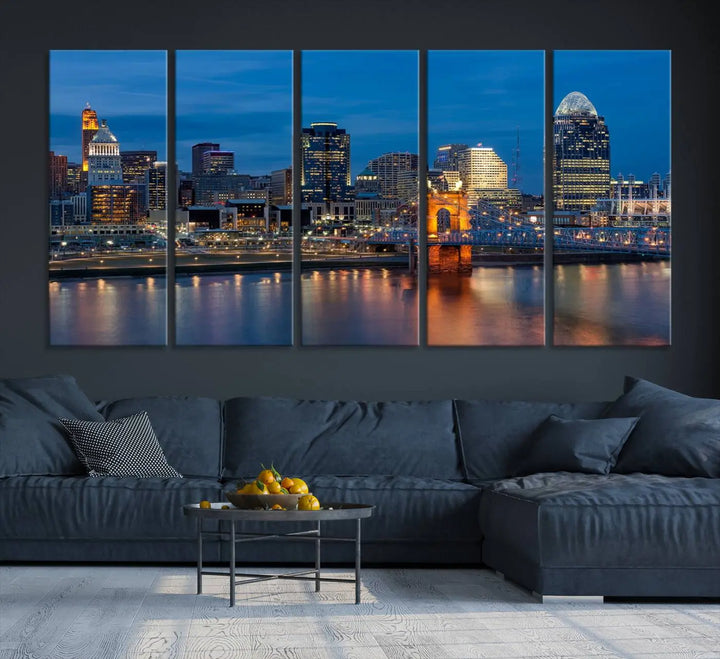 A triptych of the Cincinnati city lights night skyline, printed on museum-quality canvas with a UV-protective coating, hangs prominently on the wall.