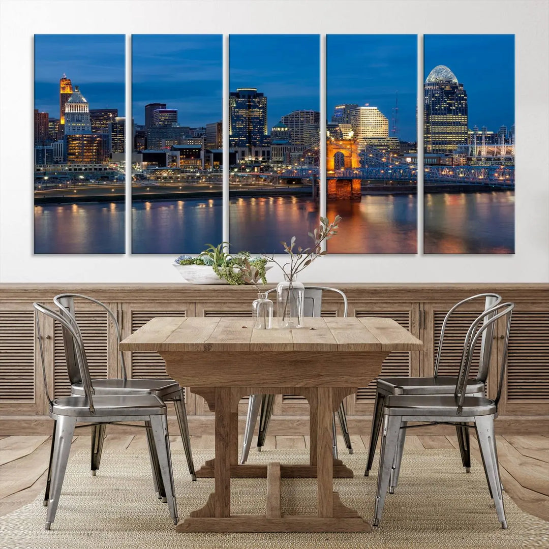 A triptych of the Cincinnati city lights night skyline, printed on museum-quality canvas with a UV-protective coating, hangs prominently on the wall.