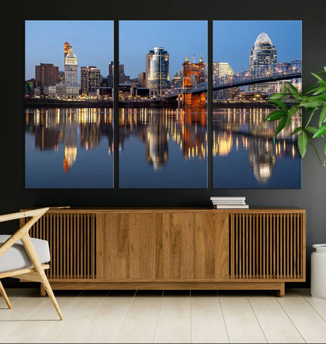 The Cincinnati City Lights Night Skyline Cityscape View Wall Art Canvas Print elegantly hangs, its vibrant reflections dancing on the water. The gallery-wrapped image is crafted on museum-quality canvas, ensuring a stunning display.