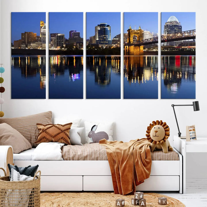 The Cincinnati City Lights Night Skyline Cityscape View Wall Art Canvas Print showcases a cityscape at night reflecting on water. It is crafted on museum-quality canvases with a UV-protective coating.